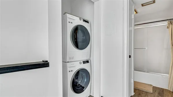a view of a hallway with washer and dryer