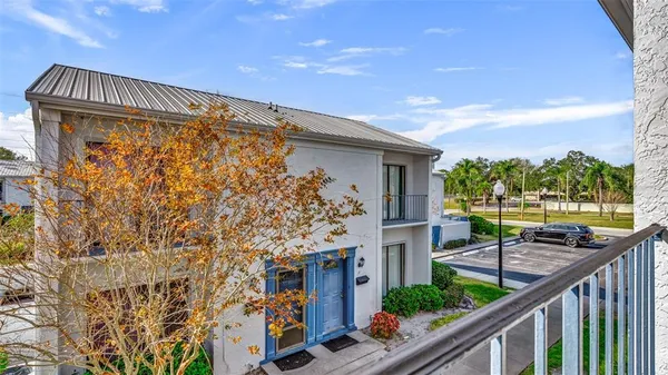 a view of a chairs and table in the balcony