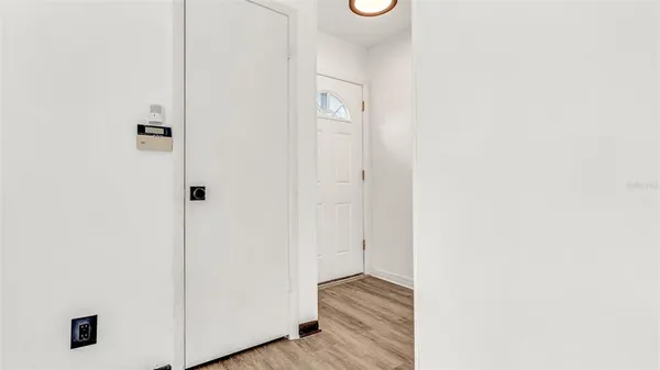 a view of a hallway with wooden floor