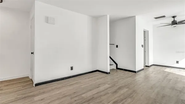 a view of a room with wooden floor