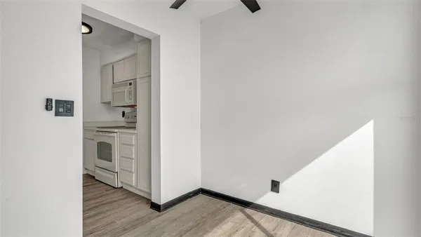 a view of kitchen and hallway with wooden floor