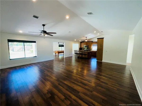 an empty room with wooden floor and a window
