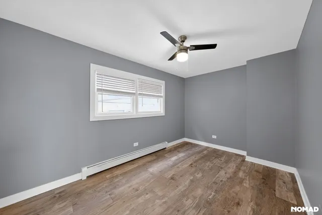a view of a big room with wooden floor closet and windows