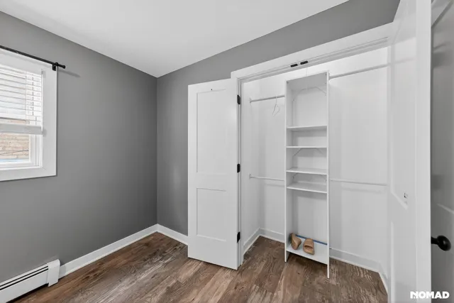 a view of walk in closet with empty racks