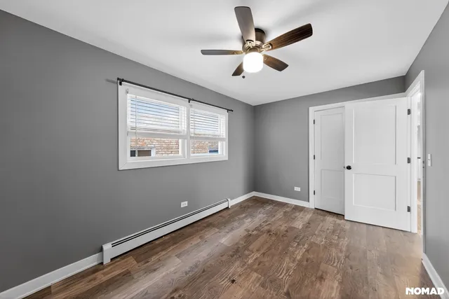 a view of room with window ceiling fan and hardwood floor