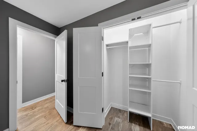 a view of walk in closet with empty racks