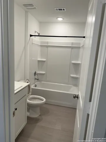 a bathroom with a bathtub toilet and shower