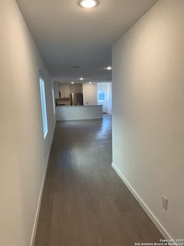 a view of a hallway with stairs