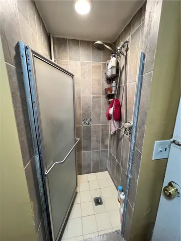 a bathroom with a sink and glass door shower