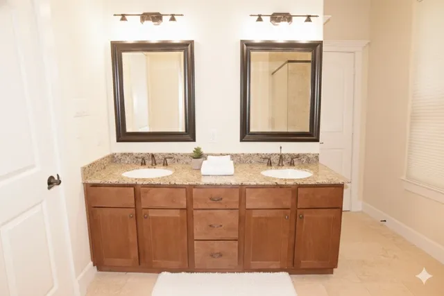 a bathroom with 2 sink and a mirror