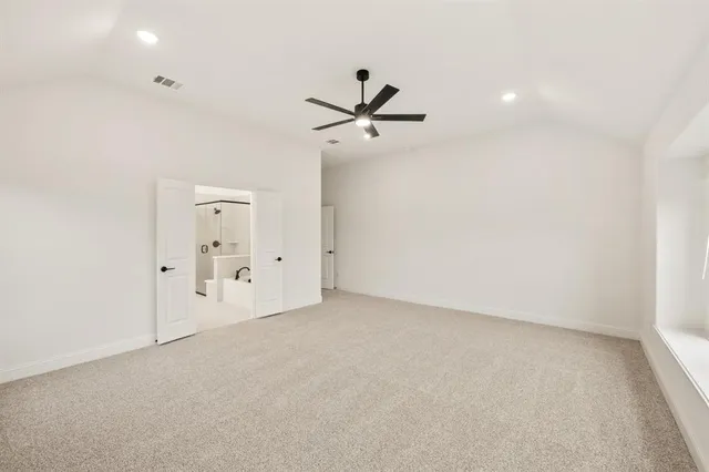 an empty room with fan and windows