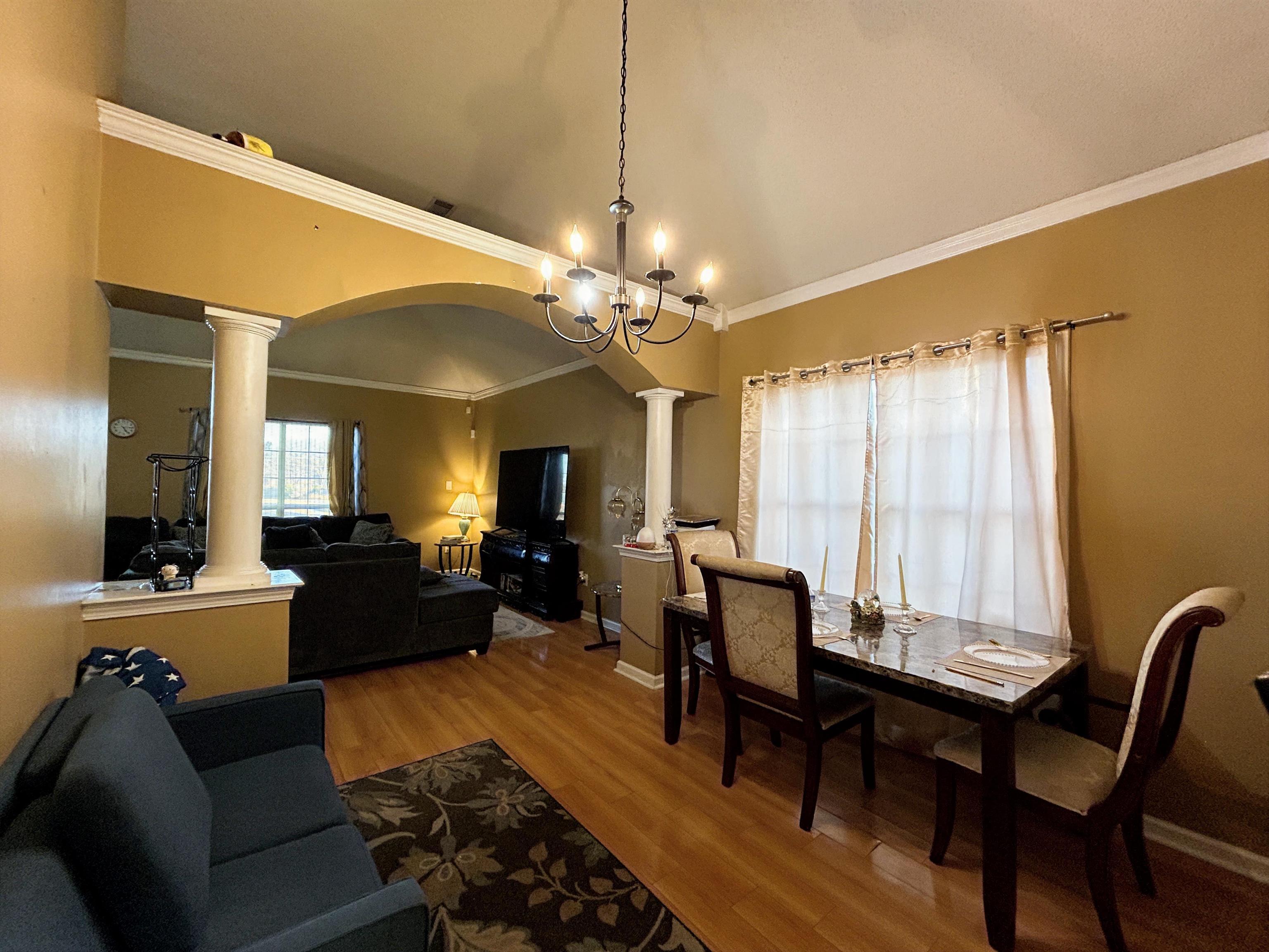 741 North Sanga Road Memphis, TN 38018 - Photo 12 of 13 Dining area with arched walkways, ornate columns, ornamental molding, lofted ceiling, and light wood-type flooring