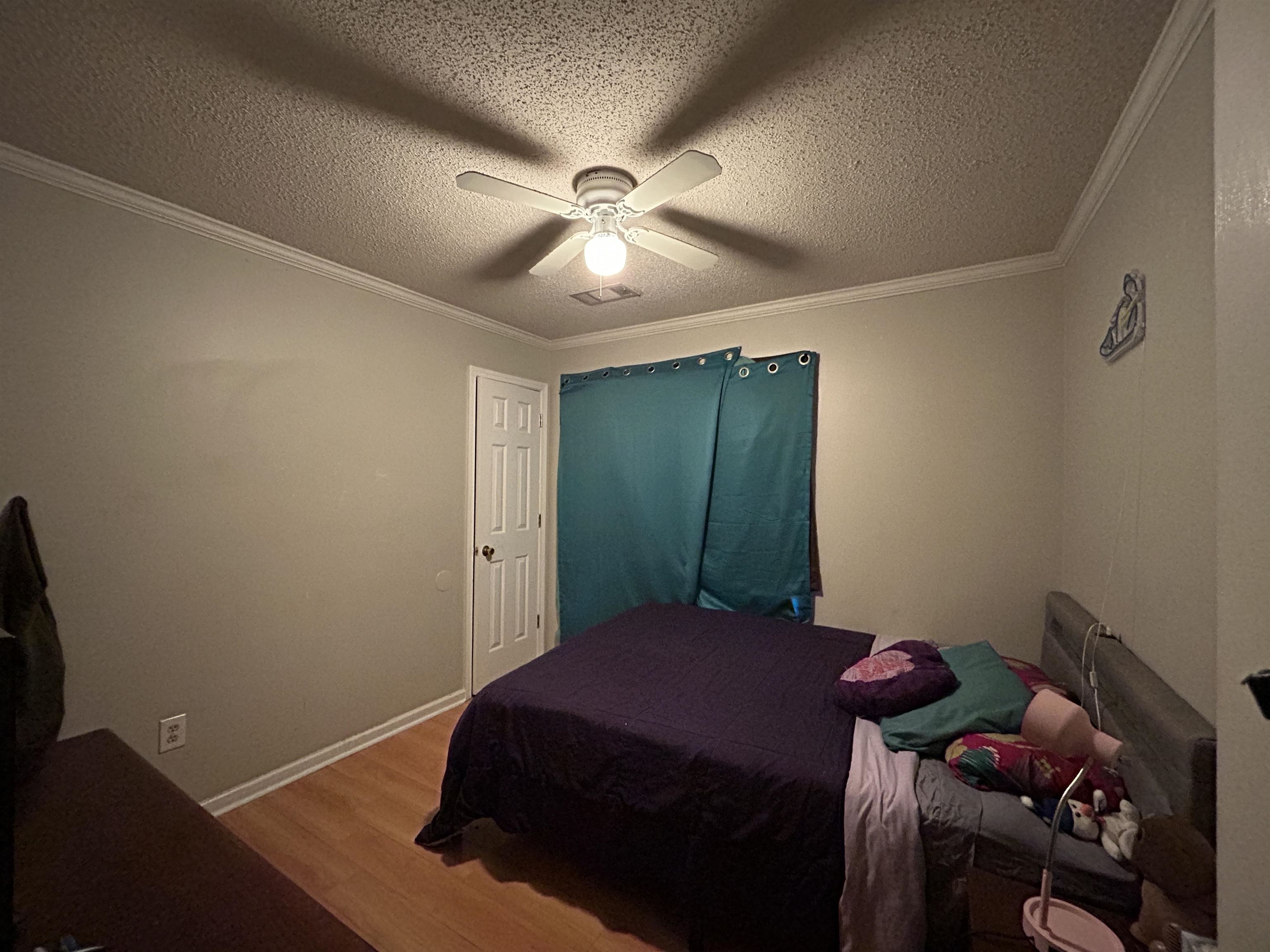 741 North Sanga Road Memphis, TN 38018 - Photo 7 of 13 Bedroom with ornamental molding, a textured ceiling, wood finished floors, and a ceiling fan
