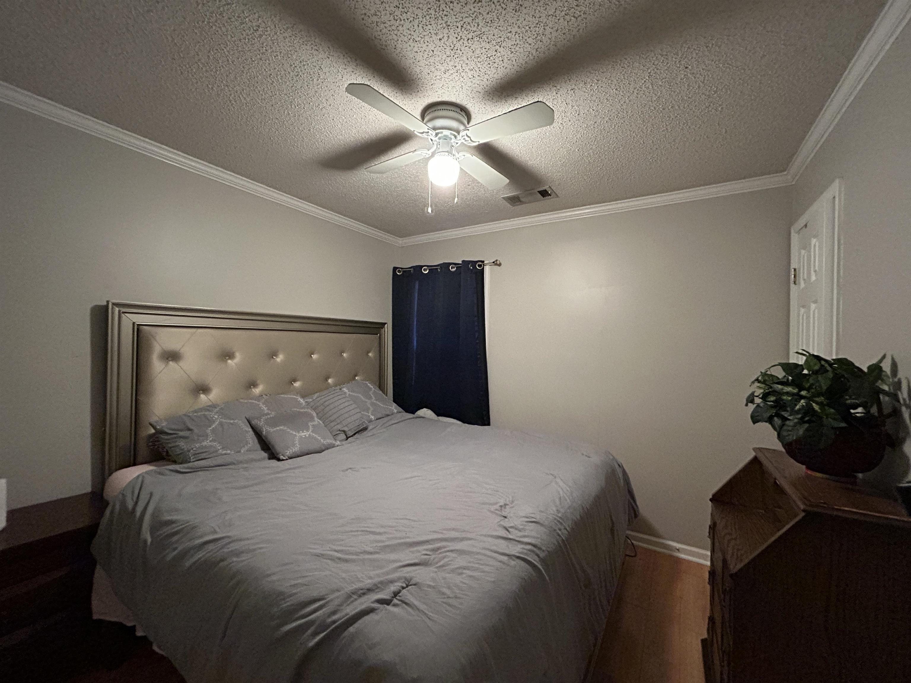 741 North Sanga Road Memphis, TN 38018 - Photo 8 of 13 Bedroom with crown molding, a textured ceiling, a ceiling fan, and wood finished floors