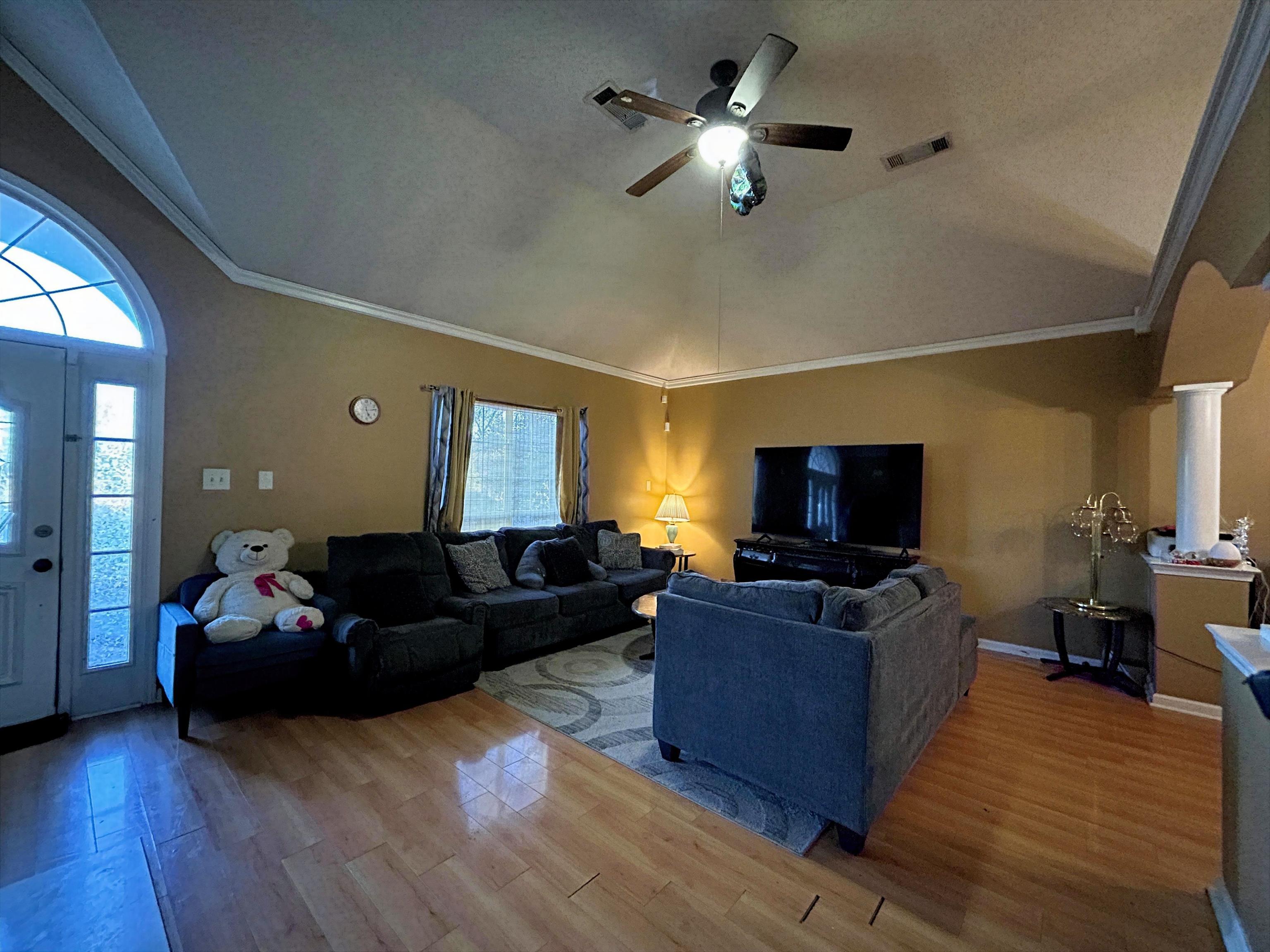 741 North Sanga Road Memphis, TN 38018 - Photo 9 of 13 Living room with crown molding, vaulted ceiling, wood finished floors, and ceiling fan