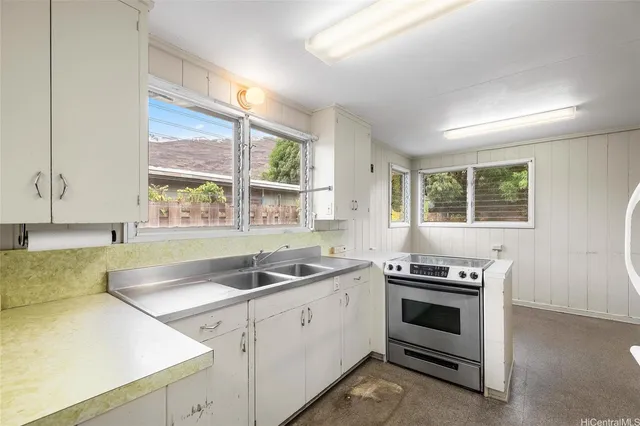 a kitchen with stainless steel appliances a sink a stove and refrigerator