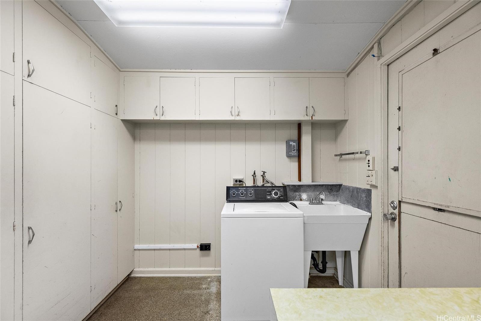 5558 Pia Street Honolulu, HI 96821 - Photo 12 of 25 a kitchen with stainless steel appliances a sink a stove and refrigerator