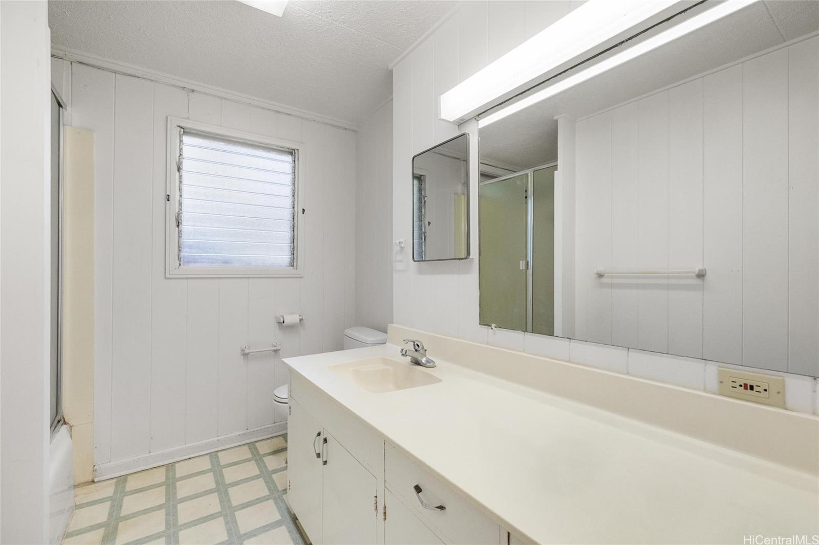 5558 Pia Street Honolulu, HI 96821 - Photo 5 of 25 a spacious bathroom with a tub sink and mirror