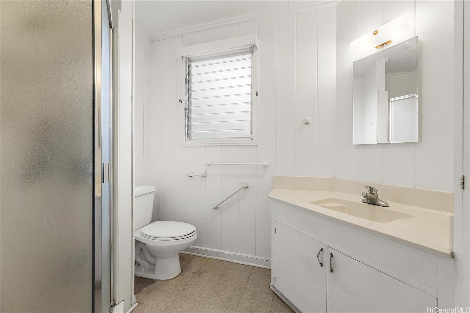 5558 Pia Street Honolulu, HI 96821 - Photo 8 of 25 a bathroom with a sink a toilet and a mirror