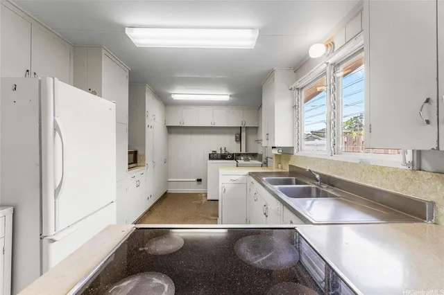 a kitchen that has a sink and a stove