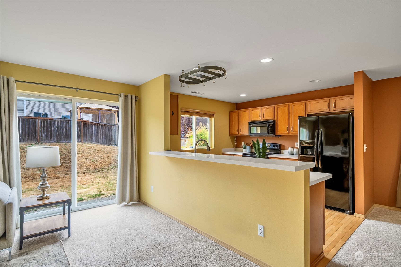 15513 38th Drive Southeast Bothell, WA 98012 - Photo 11 of 25 a view of a kitchen with furniture a ceiling fan and windows