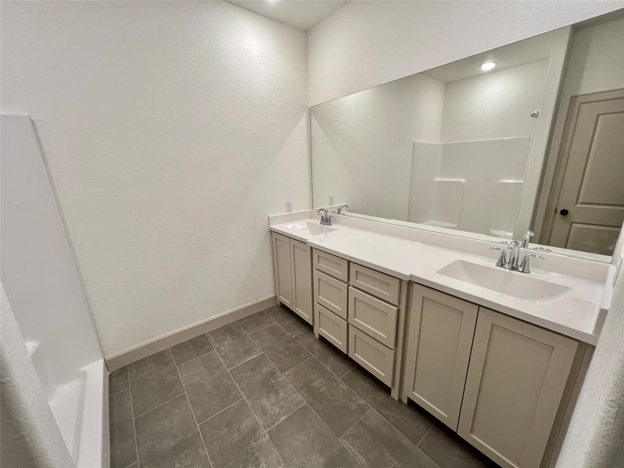 1003 South Anderson Street Angleton, TX 77515 - Photo 16 of 20 a spacious bathroom with a double vanity sink and mirror