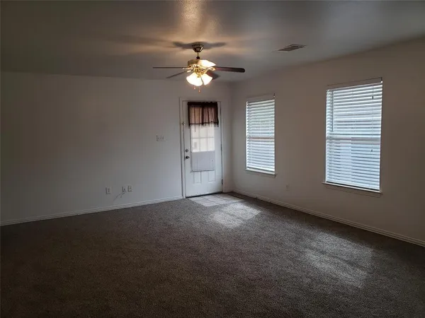 a view of an empty room with a window