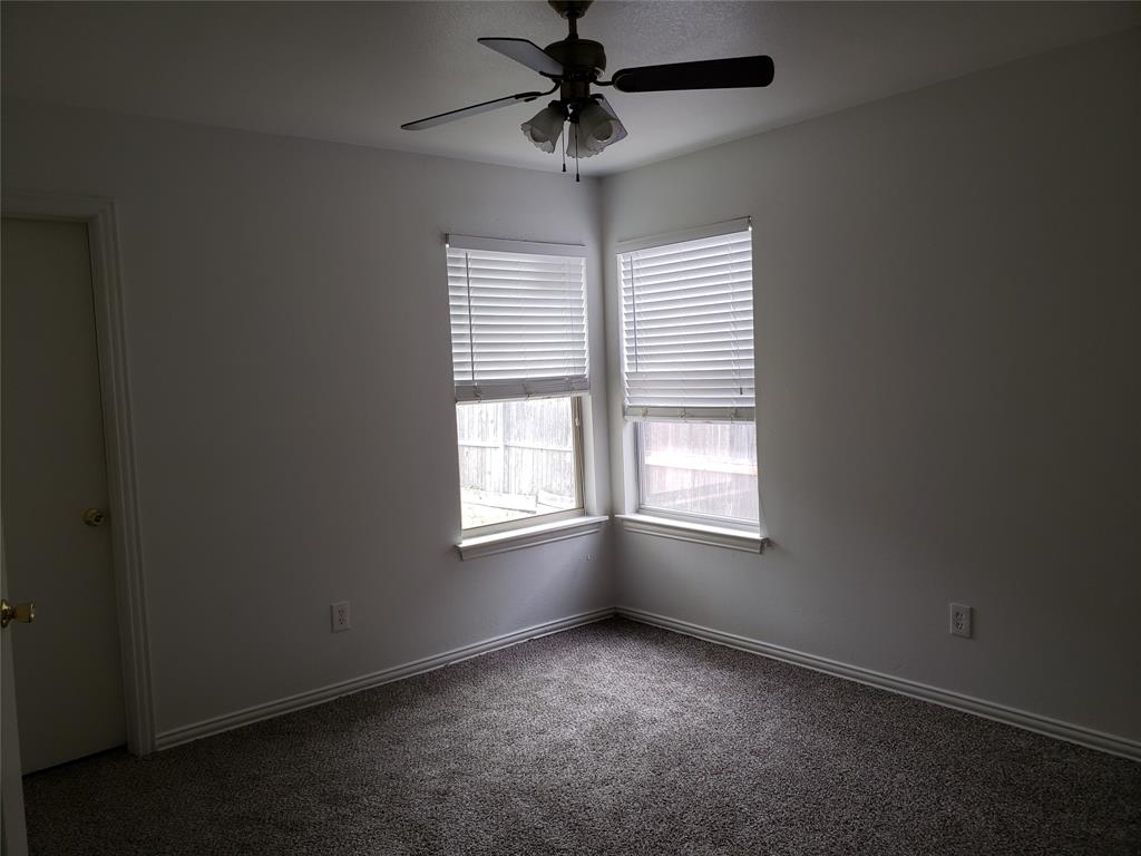 13631 Biggs Street Dallas, TX 75253 - Photo 13 of 17 an empty room with windows and chandelier fan