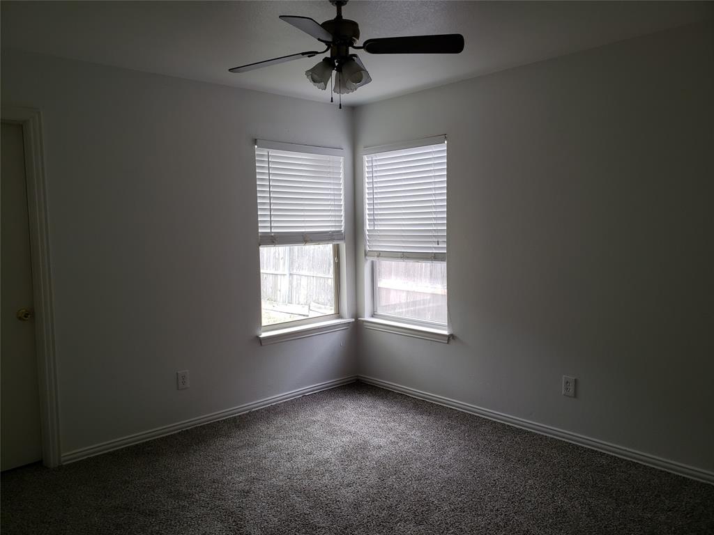 13631 Biggs Street Dallas, TX 75253 - Photo 14 of 17 an empty room with windows and chandelier fan