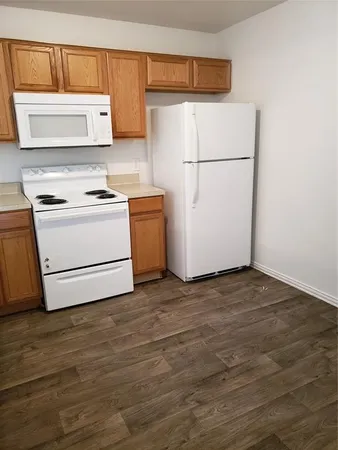 a white refrigerator freezer sitting in a kitchen