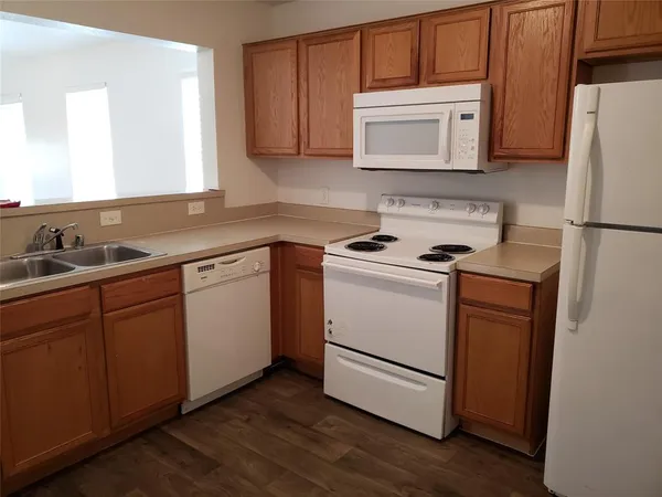 a kitchen with a sink stove and microwave