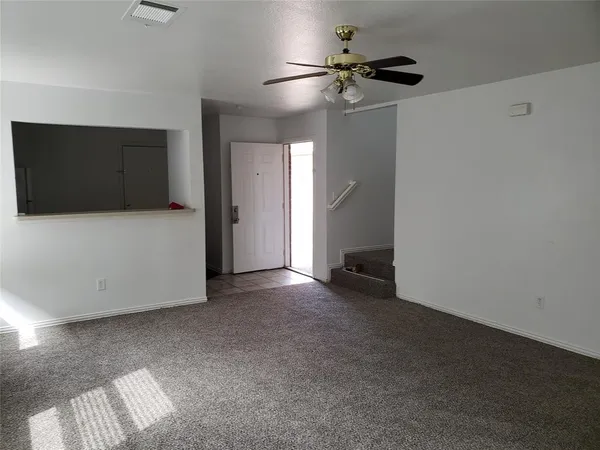 a view of an empty room with a bathroom