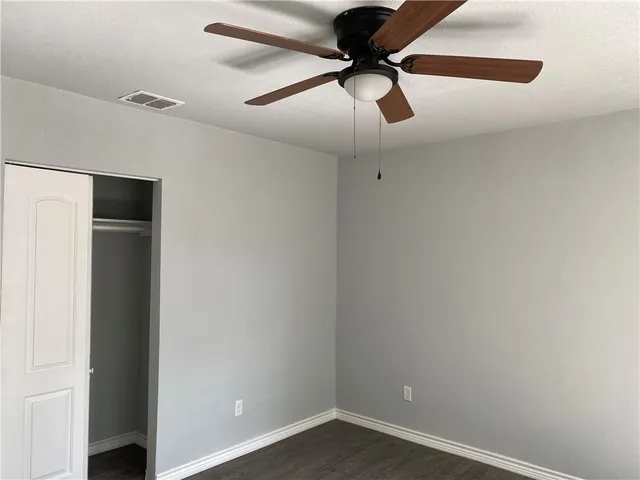 a view of a room with a ceiling fan