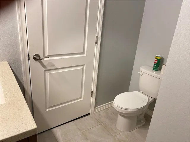 a white toilet sitting next to a sink