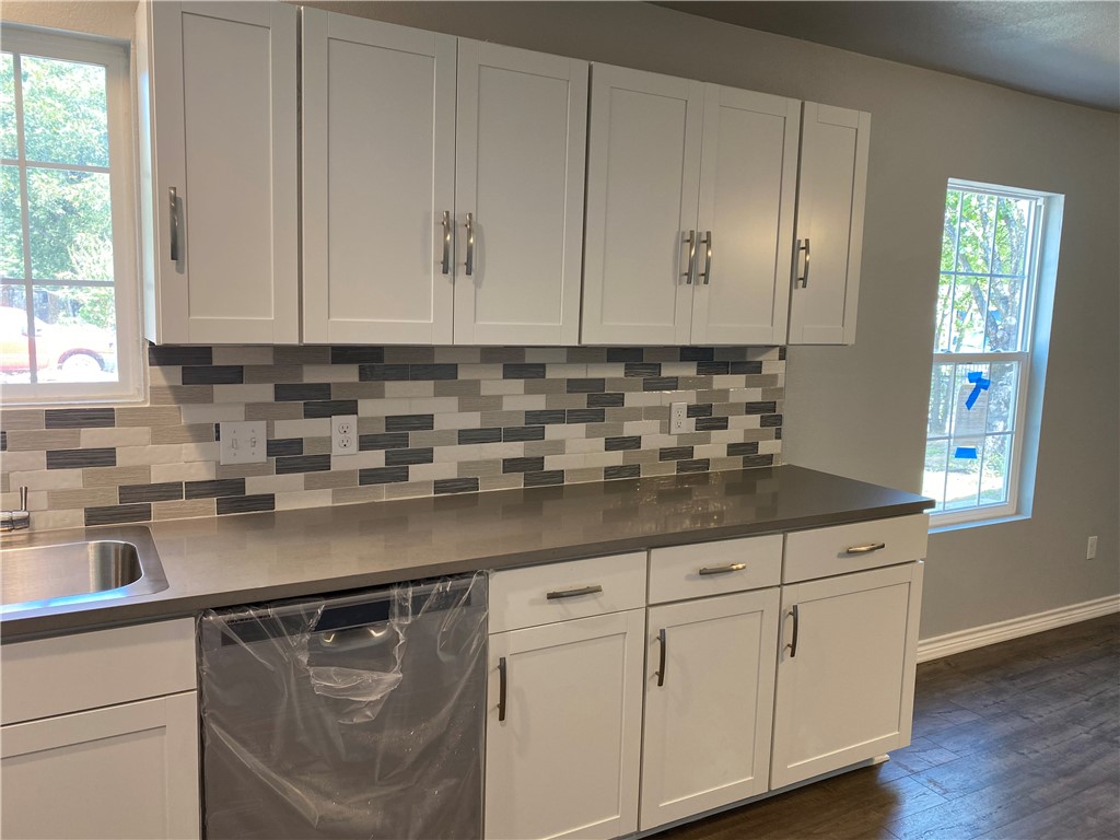 6107 Carnation Terrace Austin, TX 78741 - Photo 4 of 27 a kitchen with stainless steel appliances granite countertop a sink a stove and cabinets