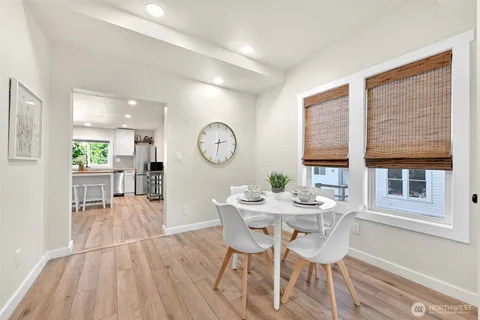 a view of a dining room with furniture and a large window