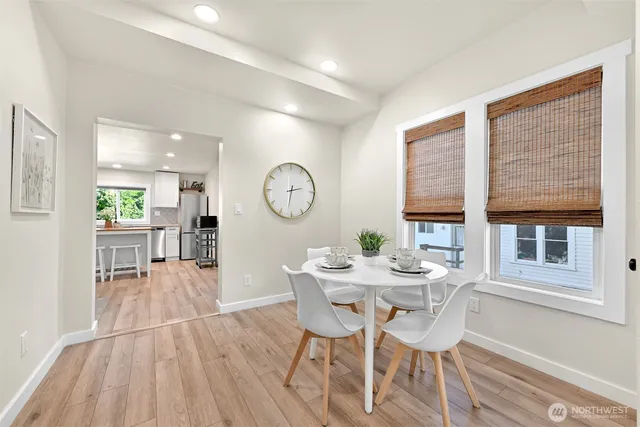 a view of a dining room with furniture and a large window