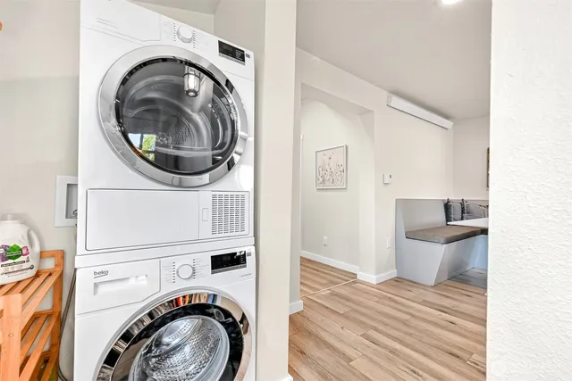 a view of a bedroom with washer and dryer