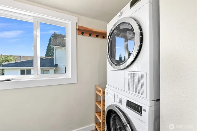 a view of a storage and utility room with washer and dryer