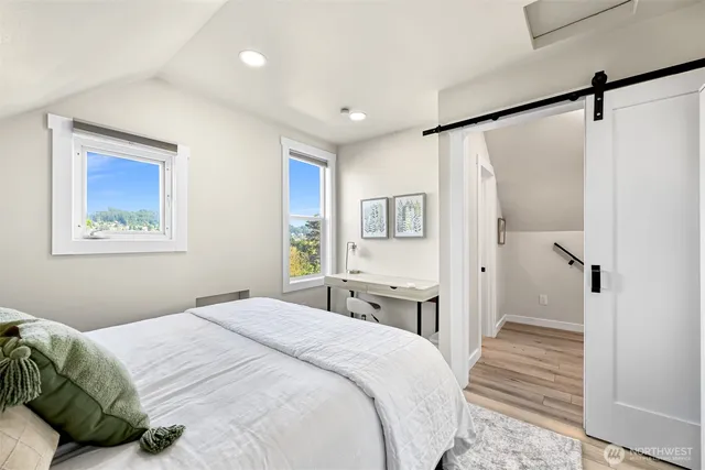 a bedroom with a bed and a painting on the wall