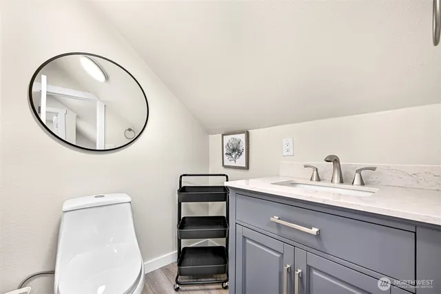 a bathroom with a toilet a sink and a mirror