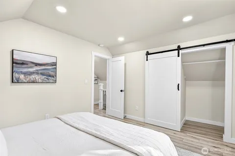 a bedroom with a bed and a shower