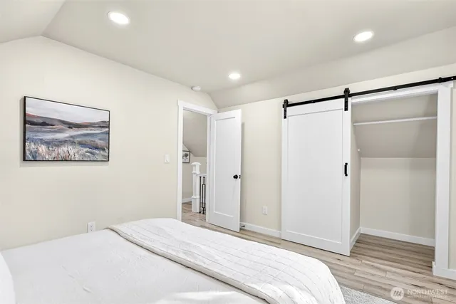 a bedroom with a bed and a shower