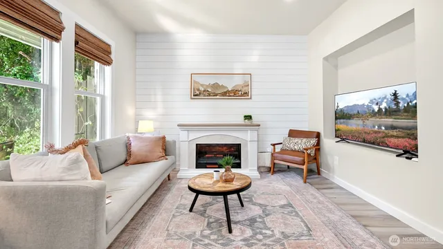 a living room with furniture a rug and a fireplace