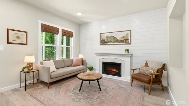 a living room with furniture a rug and a fireplace