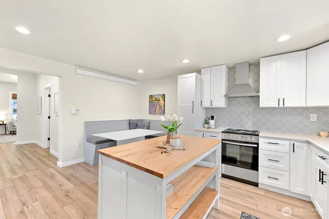 a kitchen with a stove a sink and a refrigerator