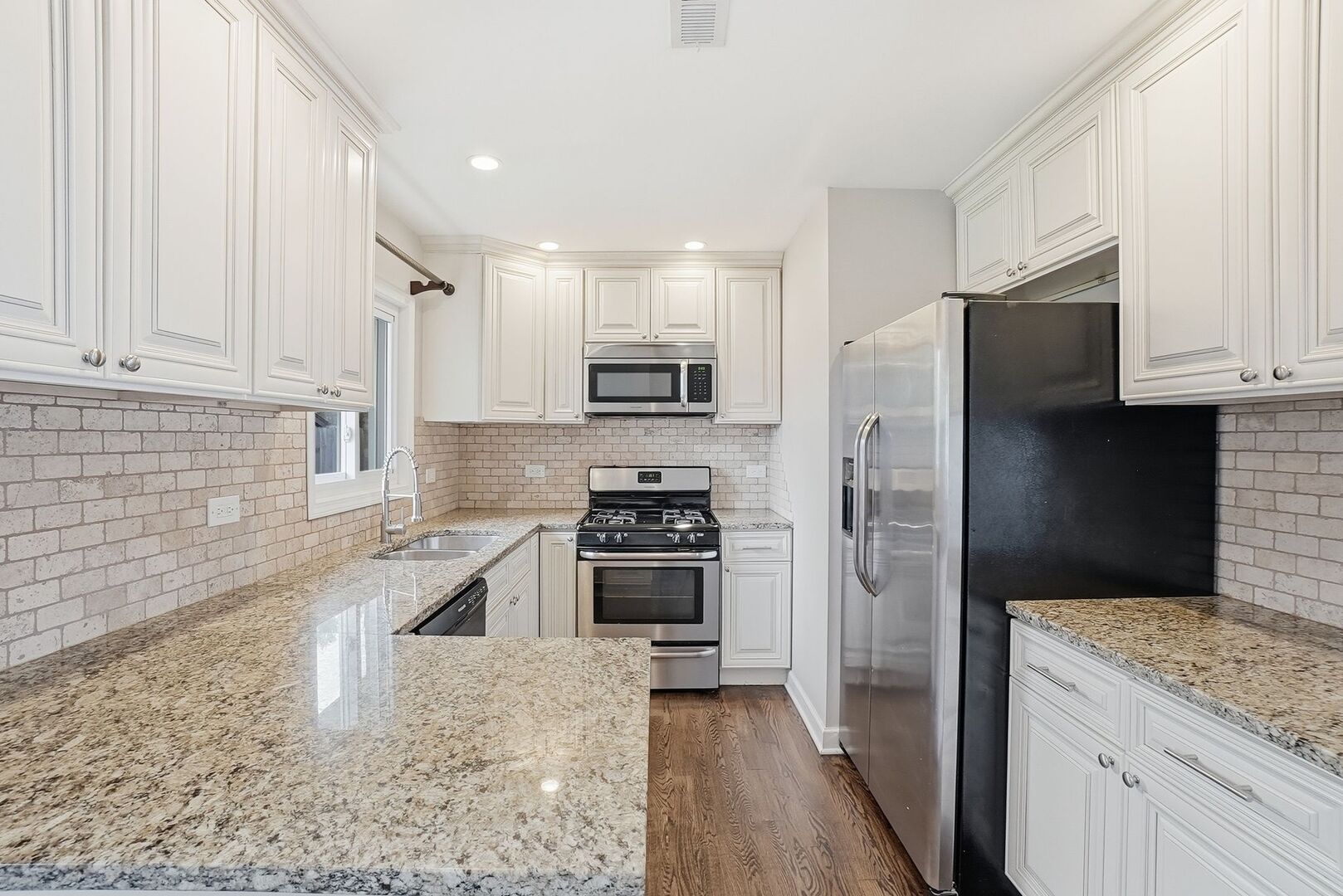 8718 Cranbrook Lane Bridgeview, IL 60455 - Photo 5 of 24 a kitchen with granite countertop a refrigerator stove and sink