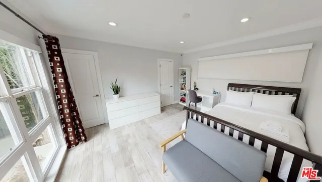 a bedroom with furniture and wooden floor