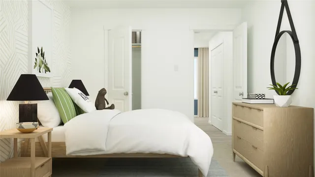 a bedroom with a bed and a flat tv screen on the dresser