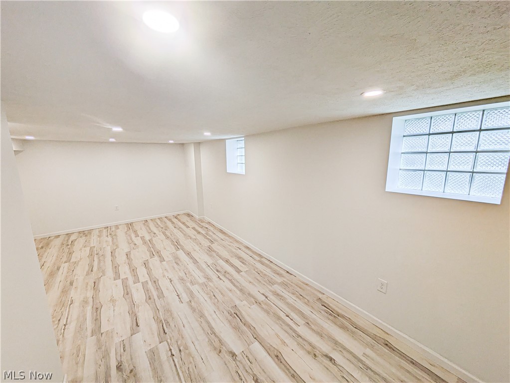 3554 Ludgate Road Shaker Heights, OH 44120 - Photo 42 of 50 Finished Basement which has space for entertaining w/ recessed lighting, wood-finish vinyl flooring, and white walls with glass block windows